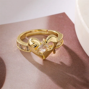 Detailed macro shot of a heart-shaped gold ring with rectangle zircon and melting metal edges