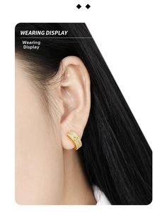 Wearing display of small gold-plated hoop earrings with micro-pave cubic zirconia crystals