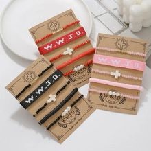 Close-up of WWJD braided wristband and cross bead bracelet sets on elegant display
