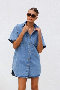 Detail of short sleeve denim shirt dress with lapel collar and chest pockets in blue