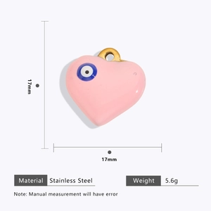 Macro view of 17mm pink heart pendant with evil eye in gold plated stainless steel