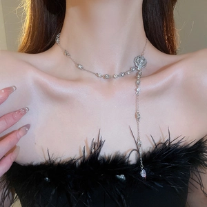 Macro view of crystal flower necklace with elegant tassel drops worn on neck