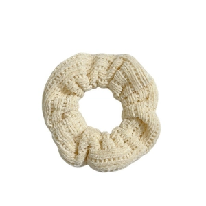 Beige knitted scrunchie with soft woven texture for ponytails, white background view