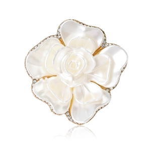 Elegant white enamel flower brooch with rhinestones and gold-plated petals on white background
