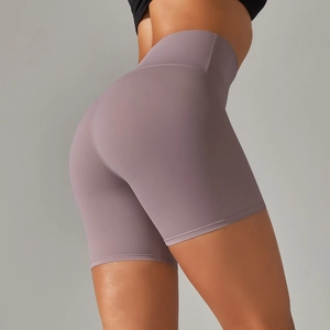Close-up of high-waist mauve yoga shorts showing elastic peach-lift fit and soft fabric