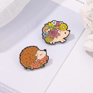 Detailed close-up of cartoon hedgehog enamel pins with colorful flower patterns