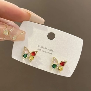 Close-up of 925 silver butterfly earrings with colorful pear-shaped gemstones