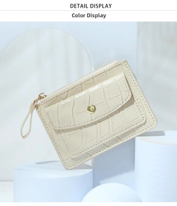 Detailed macro view of off-white crocodile pattern faux leather wallet with gold metal zipper