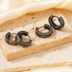 Elegant micro-paved zircon hoop earrings in black finish displayed on silk fabric