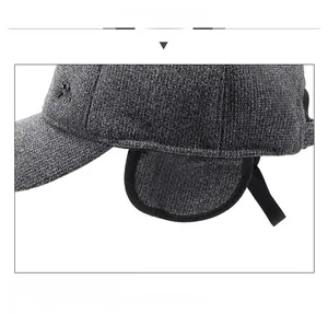 Detail view of winter baseball cap with earmuffs and metallic decorative buckle