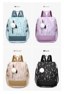 Detail view of ethnic floral backpacks in blue, purple, khaki, and black with pompom charm