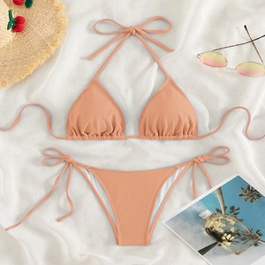 Solid apricot textured bikini set with halter top and side-tie bottoms for summer beachwear