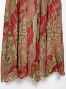 Detailed close-up of floral print midi dress featuring chiffon fabric and draped hemline