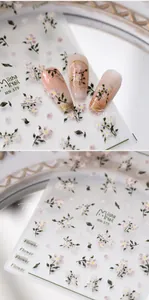 Close-up of pink floral nail stickers MN-379 applied on beige manicured nails