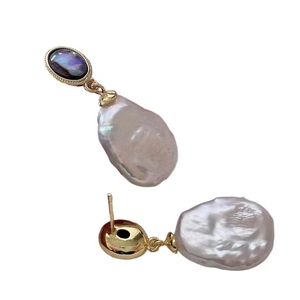 Baroque pearl earrings with abalone shell inlays and golden finish on white background