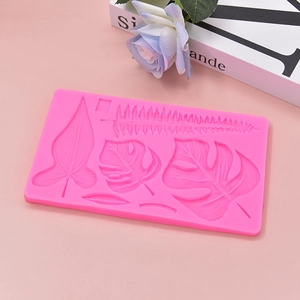 Pink silicone mold featuring tropical monstera and palm leaf designs for DIY cake decor
