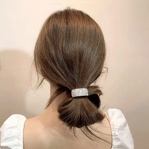 Close-up of elegant silver starfish hair ring with sparkling crystals on a ponytail