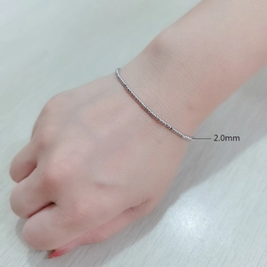 Close-up of a 2.0mm silver stainless steel beaded bracelet on a person's wrist