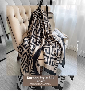 Detail of Korean houndstooth silk scarf draped on a sofa with premium maze pattern print
