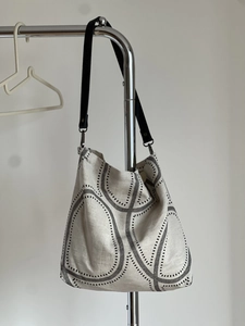 Close-up of minimalist cotton linen tote bag with abstract geometric print and black strap