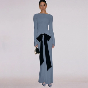 Detail view of a blue long-sleeve slim-fit dress featuring a large black bow waist decoration
