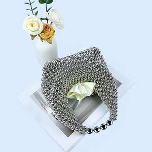 Detailed macro shot of silver beaded pillow bag featuring metallic luster and ribbon liner