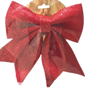 Red glitter Christmas bow ornament with gold backing card in clear retail packaging