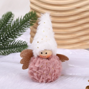 Pink plush Christmas angel ornament with gold wings and white polka dot hat on wooden background