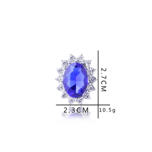 Detail view of oval sapphire engagement ring with diamond halo and 2.7cm dimensions