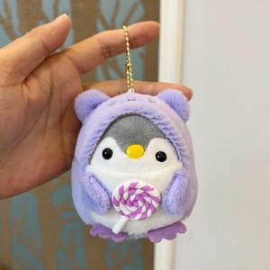 Cute penguin plush keychain wearing a purple hoodie and holding a colorful lollipop