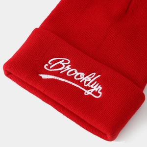 Red Brooklyn knitted beanie with white embroidery and ribbed texture for winter warmth