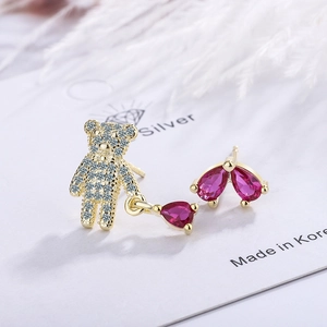 Asymmetric gold earrings with crystal-studded teddy bear and pear-shaped pink gemstones