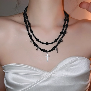 Y2K double-layer black beaded necklace with silver cross pendant shown on a model