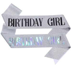 Detail of silver glitter birthday girl sashes with black and holographic lettering