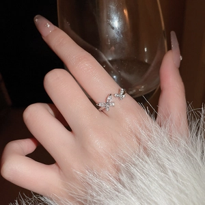 Close-up of zircon butterfly open ring worn on finger with elegant silver finish
