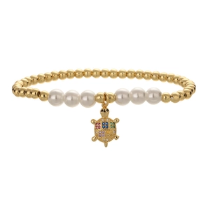 Elegant gold bead and pearl bracelet with a colorful gemstone tortoise charm