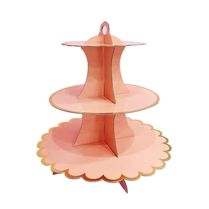 Three-tier pink paper cupcake stand with gold scalloped edges and top handle