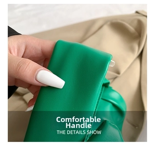 Detailed macro view of soft textured emerald green leather handle and pebble grain finish