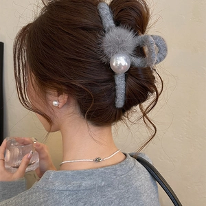 Detail view of grey flocking hair claw clip with pearls on hair for winter hair styling
