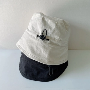 Detail of adjustable drawstring buckle and fabric texture on summer bucket hats