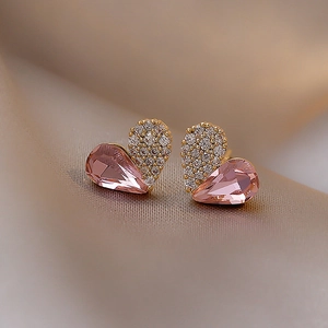 Detail of gold heart earrings with pink teardrop crystal and sparkling clear cubic zirconia
