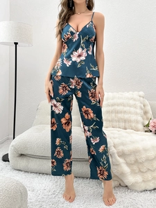 Detailed view of women's floral faux silk pajama set featuring a V-neck camisole and pants