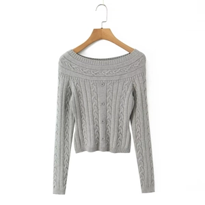 Détail du cardigan gris en maille torsadée avec col bardot et boutons décoratifs