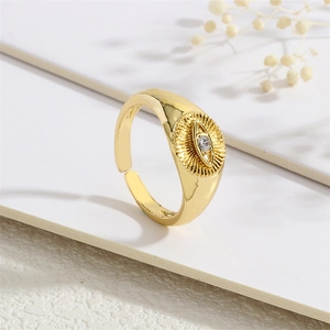 Macro shot of gold plated evil eye ring featuring sparkling cubic zirconia and open band