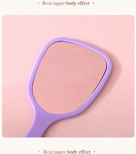 Close-up of a rectangular purple handheld mirror with a minimalist ergonomic handle