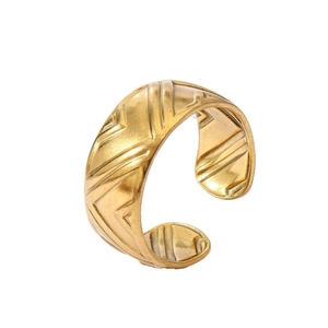 Detail of 18k gold plated ring featuring a chevron geometric pattern and open band design