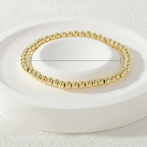 Macro detail of 4mm 18K gold-plated beaded elastic bracelet with 17cm circumference