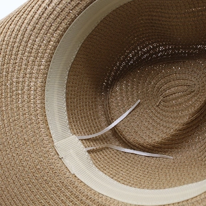 Detail of internal sweatband and adjustable drawstring on woven straw sun hat