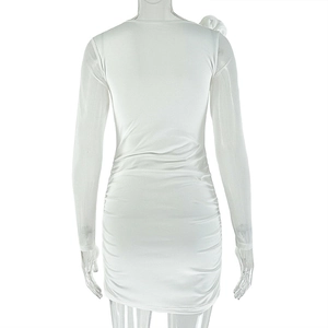 Detailed back view of white ruched mini dress with shoulder flower and slim fit design