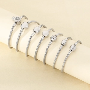 Set of 7 silver stainless steel snake bone bracelets with crystal crown and heart clasps